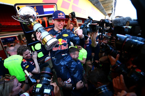 Max Verstappen celebrates with the team in the pit lane 